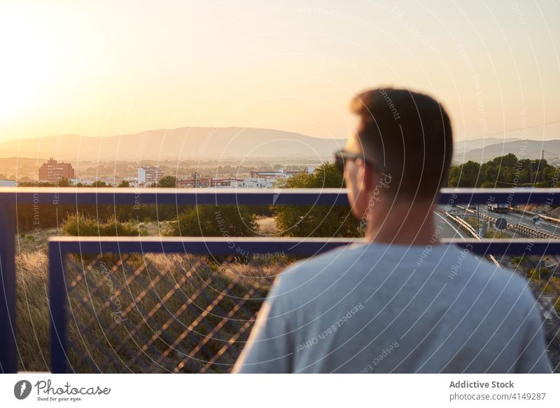 Man with guitar in city looking away musician man guitarist bridge calm serious talent player male case confident handsome relax modern urban sound instrument