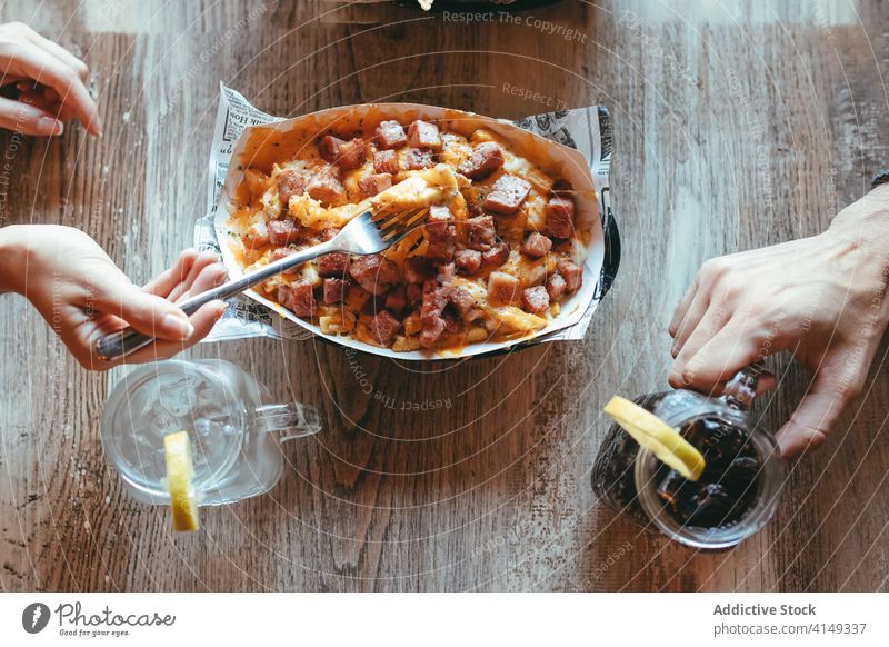 Friends eating delicious snacks in cafe food friend together meeting meal bacon fries lunch fried gather yummy group people hand tasty restaurant dinner dish