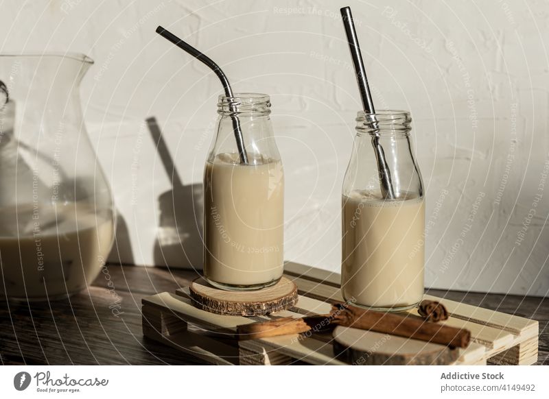 Bottles with milkshake on wooden table bottle homemade healthy cinnamon food drink fresh breakfast beverage natural tasty dessert sweet glass delicious yummy