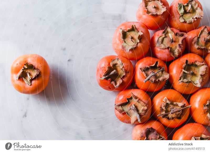 Fresh persimmon on table in kitchen fruit vitamin ripe fresh healthy food sweet nutrition fiber diet nutrient delicious bright natural organic home meal tasty