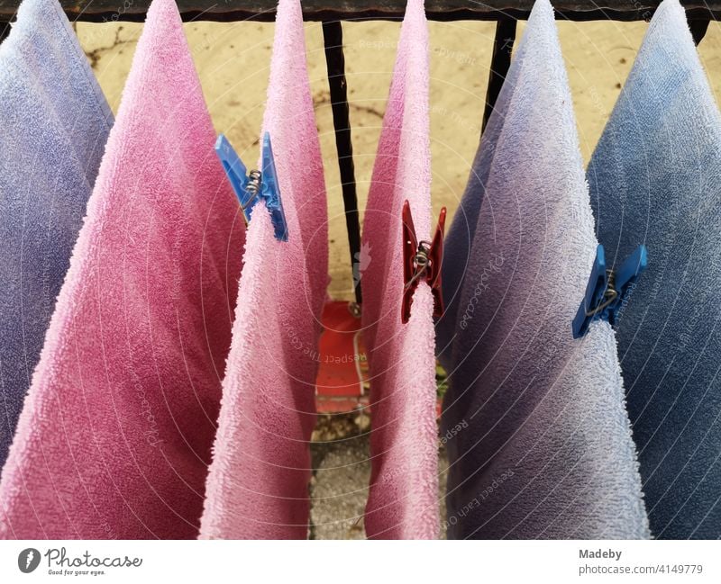 Towels made of terry cloth in pink and light blue with matching clothes pegs on a balcony in the old town of Bursa in Turkey Terry cloth terry towel Pink Colour