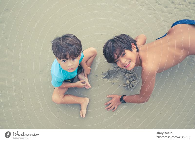 Cute kids having fun on sandy beach in summer day laugh recreation friends outside vacations little weekend hot cute two running playful nature colourful family