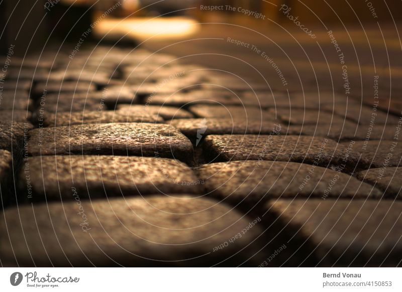 Cobblestones in the evening light Evening Sunset Sunlight Close-up Warm light traditionally Rough Shadow Light Town out of focus Soft Brown Back-light Street