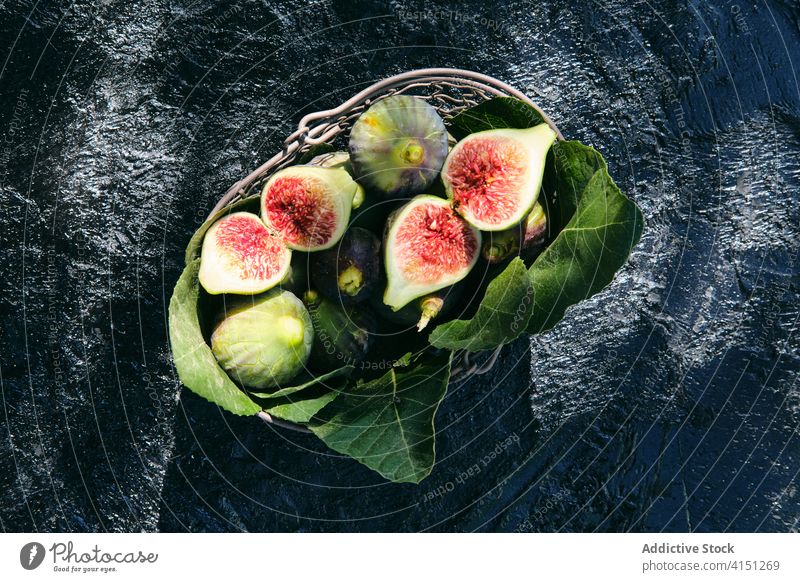 Fresh figs and green leaves in basket fruit fresh natural food leaf organic vitamin veggie ripe delicious ingredient raw nutrition vegetarian vegan harvest