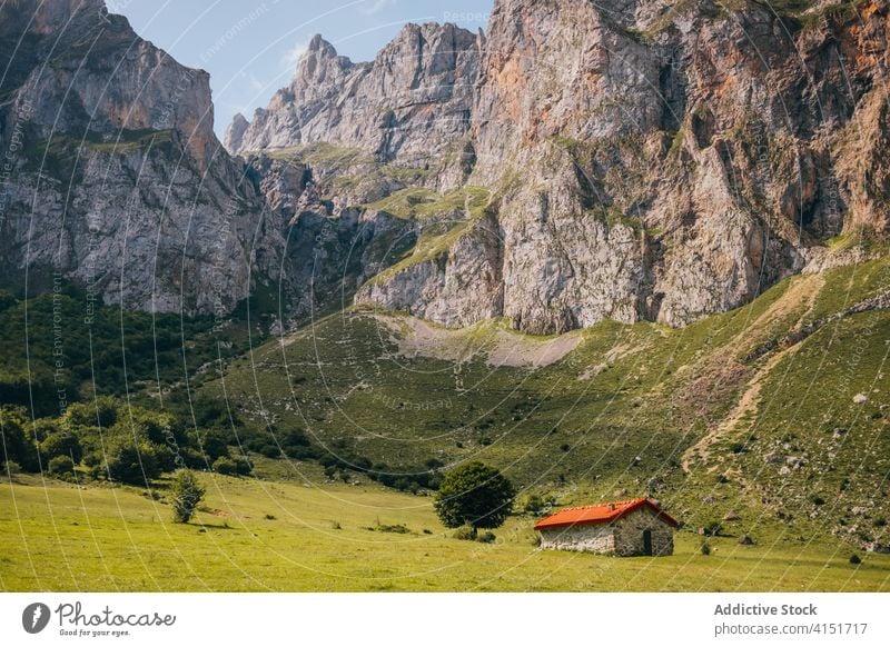 Stone house in green mountain valley range residential stone picos de europa cabin meadow landscape asturias spain scenic small ridge sunny majestic nature