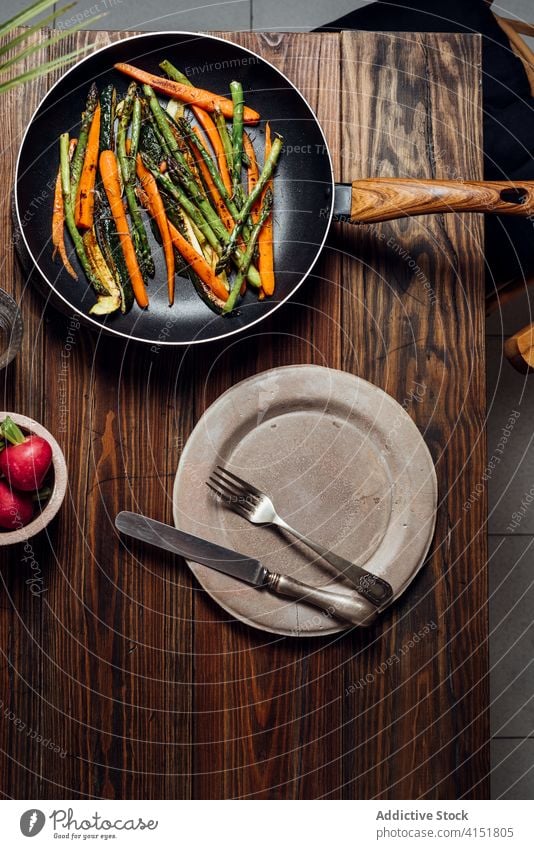 Carrot, asparagus and zucchini sauteed in the pan, on the table gourmet carrots concept modern mix new traditional background prepared recipe rustic vegetarian