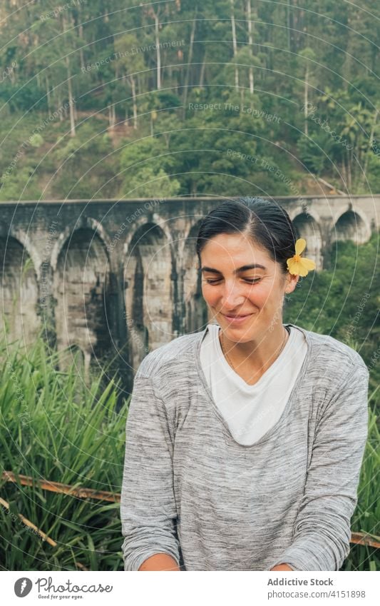 Ethnic woman against old bridge in nature traveler jungle forest activity tourism smile romantic sri lanka nine arch bridge female flower blossom happy ethnic