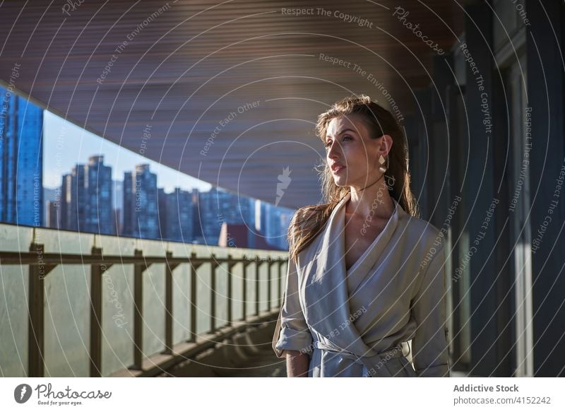 Thoughtful young woman standing near modern building thoughtful pensive lonely think urban sad female contemporary contemplate lifestyle dream alone serious