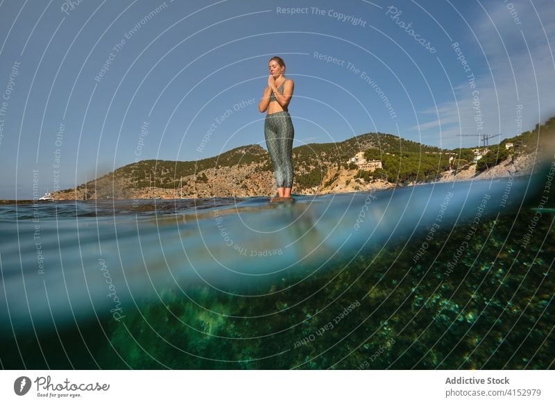 Serene woman in Mountain pose near sea mountain pose yoga meditate namaste rock asana calm harmony female tadasana relax tranquil wellness seascape summer