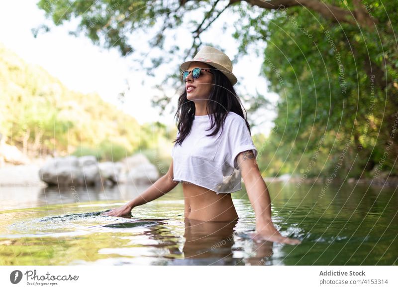 Calm woman in lake in summer forest travel enjoy vacation water pond relax female traveler carefree trip calm tourism holiday tranquil nature idyllic green