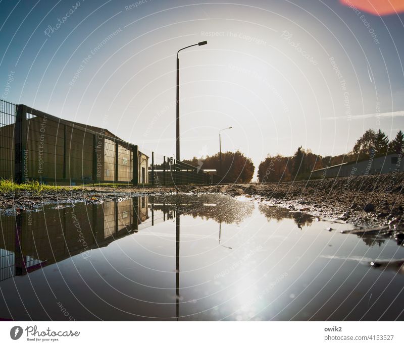 Puddle Bank Lamp post Street lighting Pole Calm Idyll Wall (building) Wall (barrier) Exterior shot Colour photo Detail Deserted Reflection Contrast