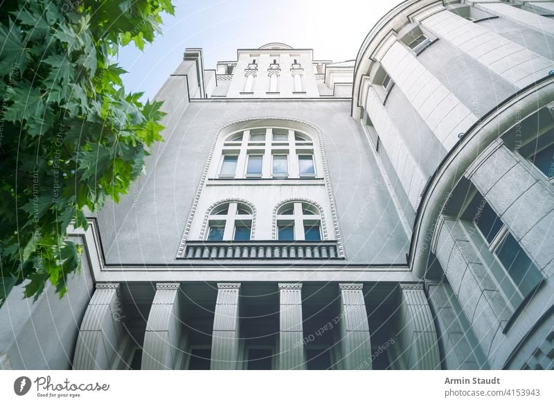 spooky looking house and green leaves Pillars apartment architecture background beautiful berlin blue building capital city cloudless decoration europe facade