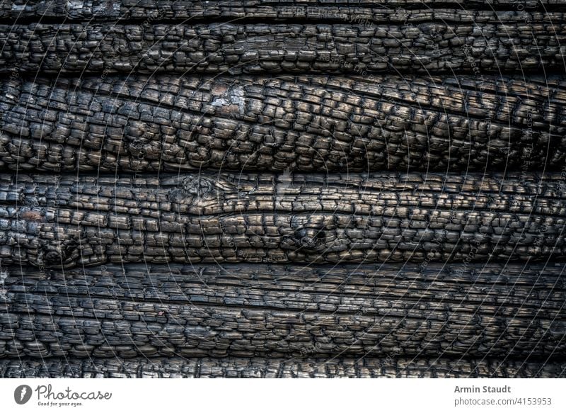 close up of a charred wall of a blockhouse abstract aged background black burn burned burnt charcoal closeup damaged dark design destruction fire golden grunge