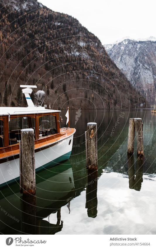 Boat moored on lake near mountains boat autumn vessel nature cold travel landscape environment germany austria water calm tranquil season scenic motor boat