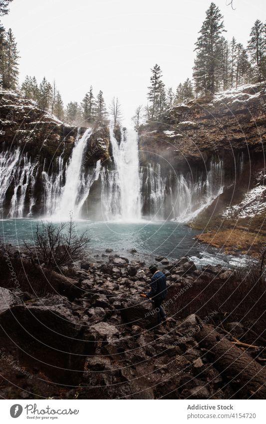 Waterfall in snowy mountainous forest in winter day waterfall flow nature landscape pool cold stream scenic picturesque scenery travel tourism usa united states