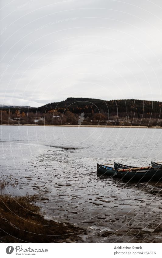 Boat on lakeside in mountains boat shore mood vessel gloomy autumn season calm scottish highlands scotland uk united kingdom paddle lonely water idyllic fall