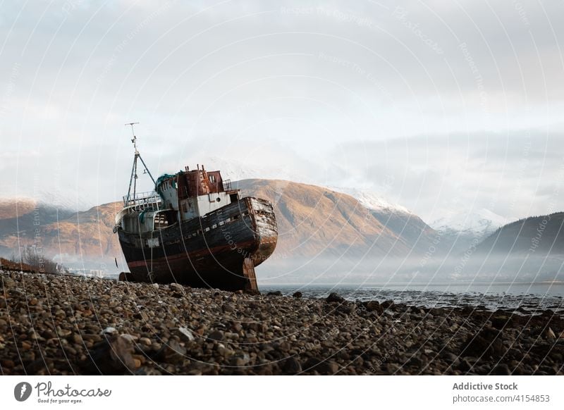 Fishing boat on shore in highland area fishing mountain moor morning fog peaceful scenery ship scottish highlands scotland uk united kingdom old nature calm