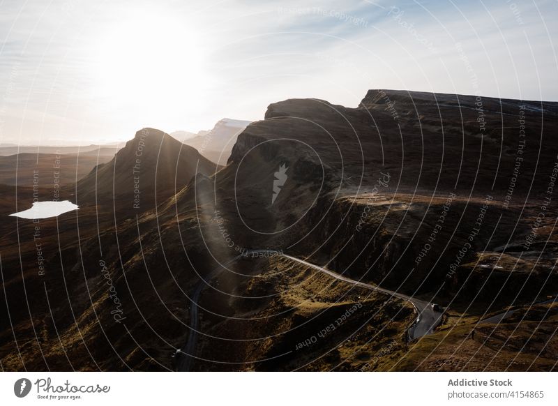 Majestic scenery of mountains in morning landscape road winding highland dawn sun breathtaking scottish highlands scotland uk united kingdom cloudy sky bright