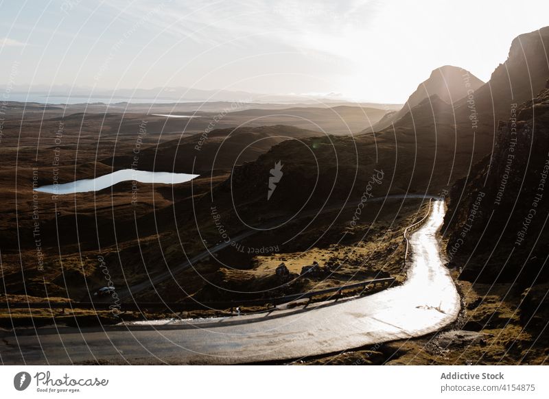 Majestic scenery of mountains in morning landscape road winding highland dawn sun breathtaking scottish highlands scotland uk united kingdom cloudy sky bright