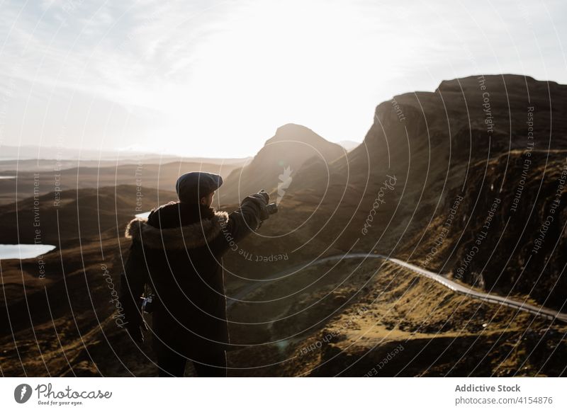 Traveling man on hill in mountains traveler autumn season highland explorer wanderlust outerwear male scottish highlands scotland uk united kingdom tourist