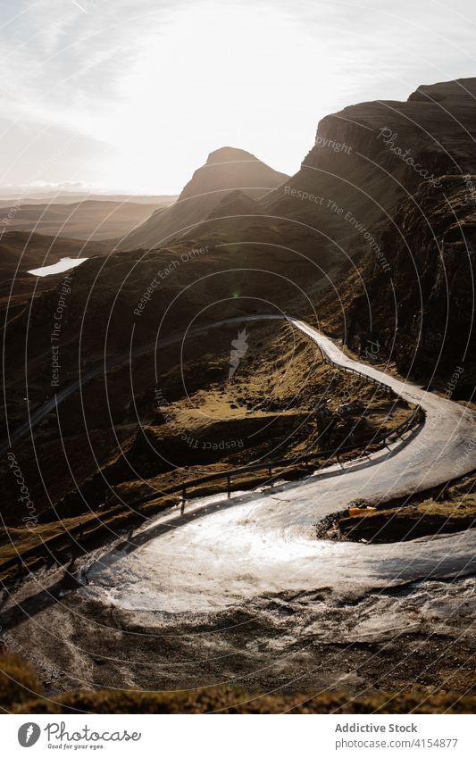 Majestic scenery of mountains in morning landscape road winding highland dawn sun breathtaking scottish highlands scotland uk united kingdom cloudy sky bright