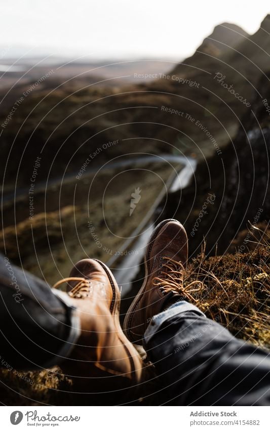 Crop traveling man on hill in highlands mountain traveler relax boot trekking tourist autumn season male scottish highlands scotland uk united kingdom nature