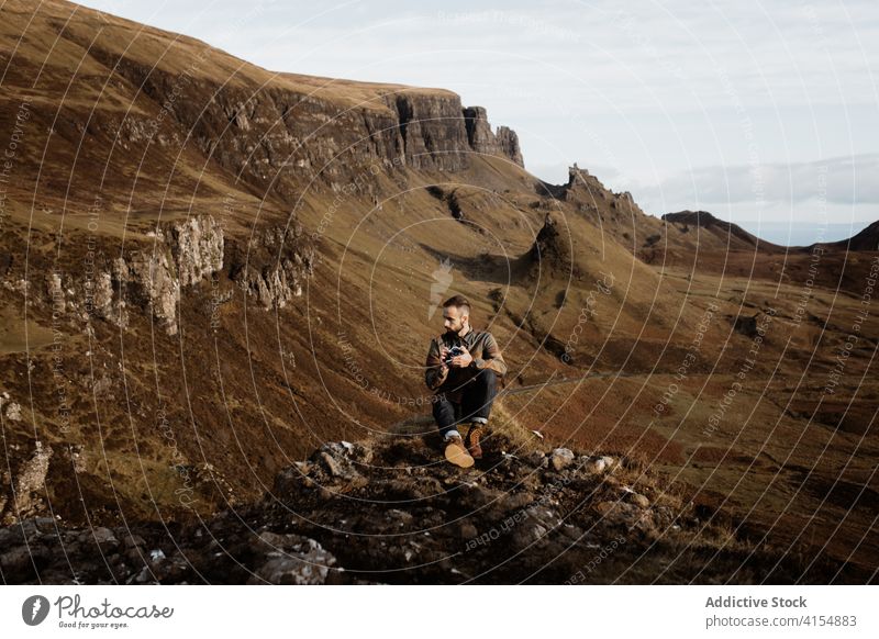 Male traveler taking photos in highland area in autumn mountain take photo man photographer landscape ridge season male scottish highlands scotland uk