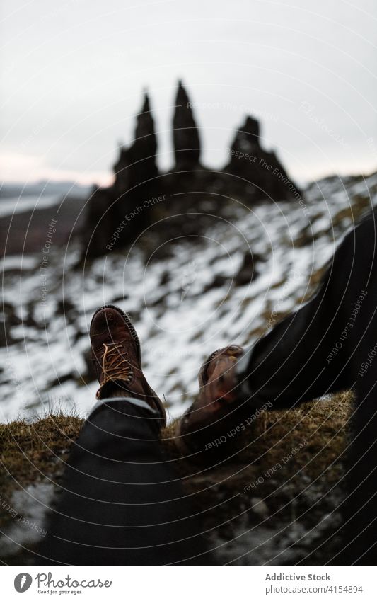 Unrecognizable male hiker on hill in winter man traveler old man of storr rock snow explore wanderlust relax scottish highlands scotland uk united kingdom