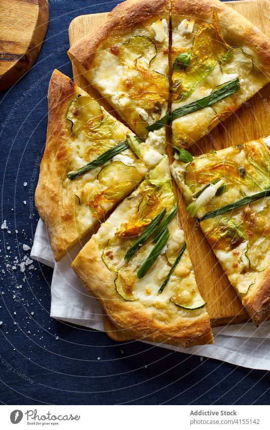 Top view of vegetarian pizza zucchini onion blue orange wine cheese crust salt italian cuisine food meal flatlay top view overhead zucchini flowers rustic