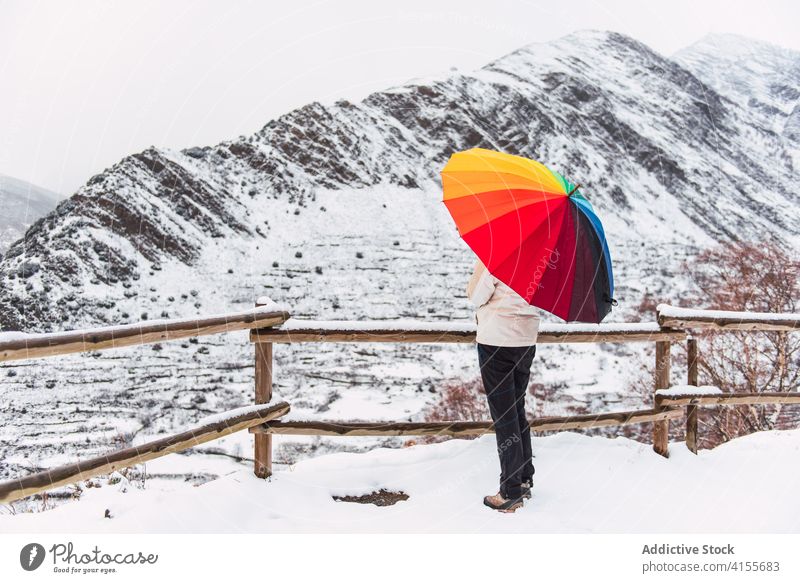 Unrecognizable person under umbrella in mountains in winter colorful highland snow enjoy landscape wintertime pyrenees catalonia spain amazing bright white