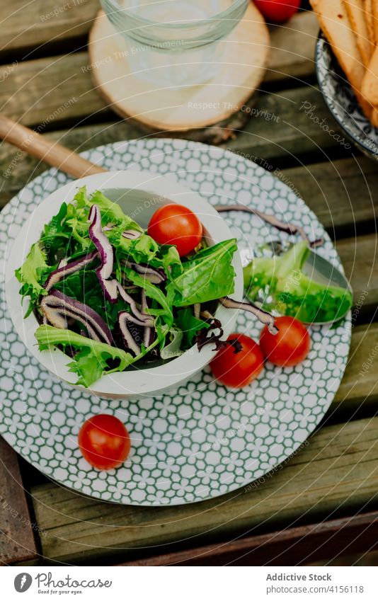 Bowl with fresh salad on table vegetable picnic forest woods bowl nutrition vitamin valle del jerte caceres spain wooden zone food meal diet tomato