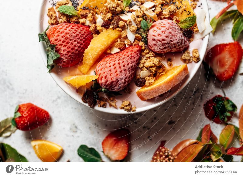 Healthy breakfast bowl with fruits on table smoothie bowl super food delicious nut nutrition healthy food raw food green plant muesli orange coconut various