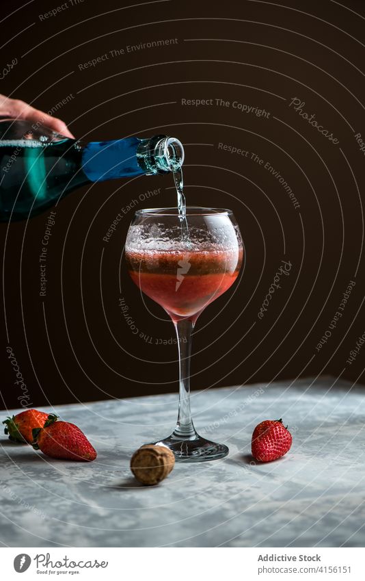 Crop woman pouring drink in glass alcohol beverage strawberry cocktail sweet table female delicious fresh prepare liquid tasty process ingredient fruit cold