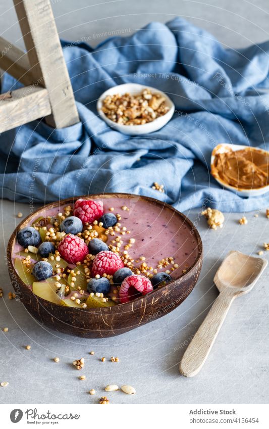 Appetizing smoothie bowl on table breakfast super food morning berry yogurt healthy delicious fresh fruit tasty yummy kiwi blueberry raspberry nutrition meal