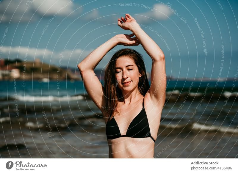 Slender woman doing yoga on the beach asana practice slim tranquil seashore bikini female amazing seascape wellness peaceful zen posture nature wellbeing