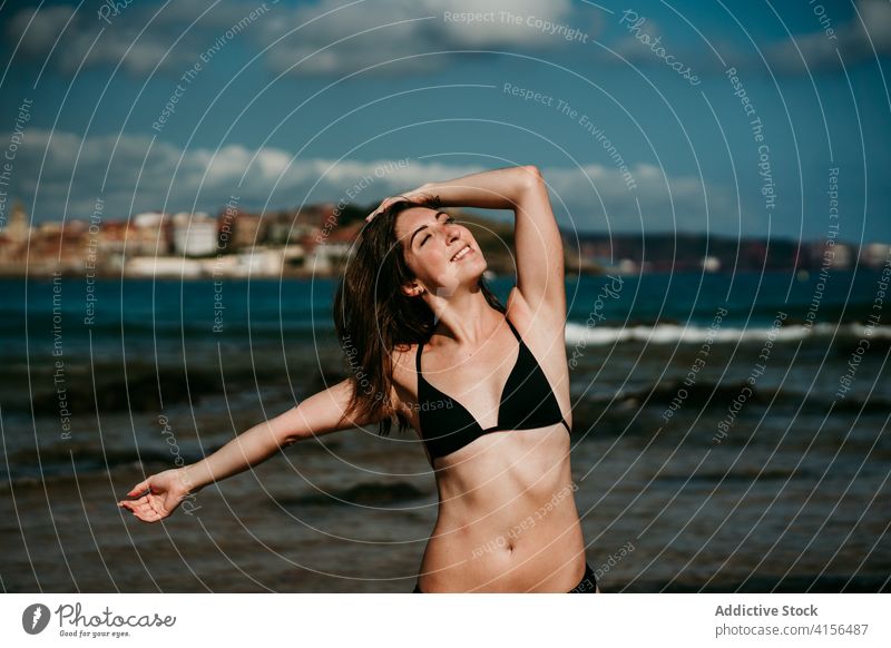 Slender woman doing yoga on the beach asana practice slim tranquil seashore bikini female amazing seascape wellness peaceful zen posture nature wellbeing