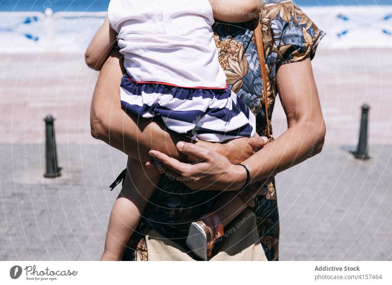 Woman with little girl on embankment in summer mother daughter sea vacation seafront promenade sunny together cute happy kid mom relax childhood parent charming