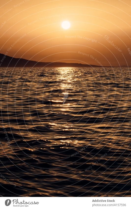 Rippling sea at sunset in evening water ripple calm surface sunlight reflection amazing color sundown scenic dusk twilight idyllic bright serene ocean tranquil