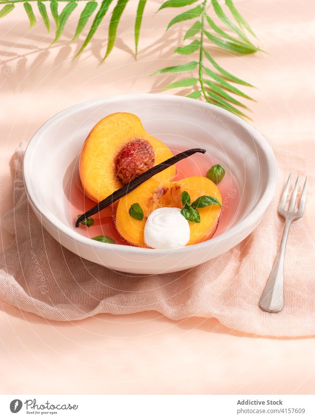 Poached Peaches in white wine, vanilla and basil. orange nectarine decoration sweet plate sauce table dish homemade warm flavour food healthy organic fruit