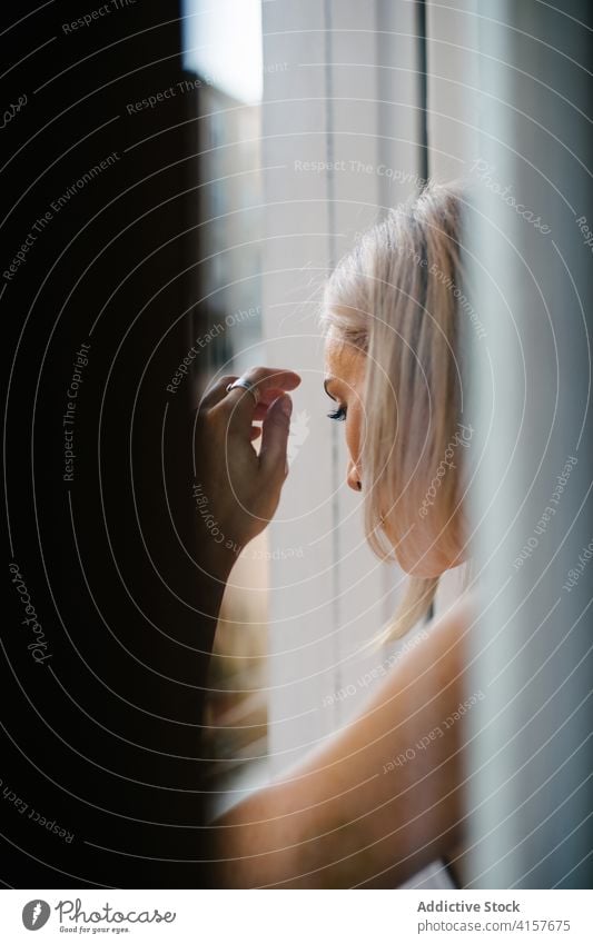 Tranquil woman looking out of window observe street home relax serene harmony thoughtful apartment female tranquil peaceful idyllic calm enjoy domestic weekend