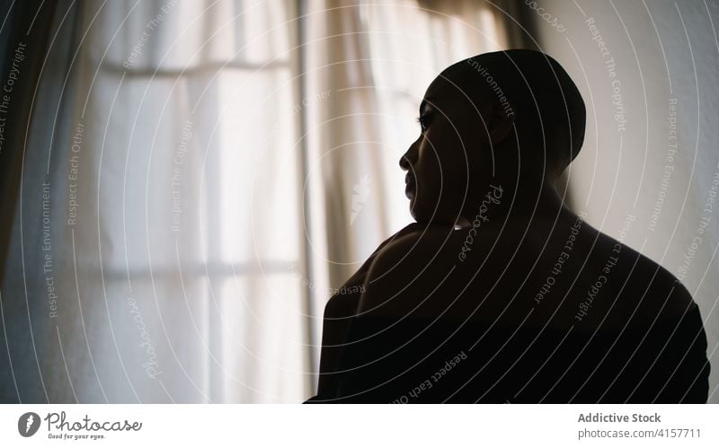 Serious black woman in towel at home calm relax serene tranquil appearance unemotional dark female ethnic african american peaceful rest harmony comfort idyllic