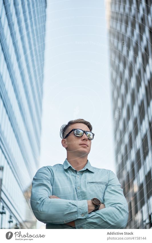 Stylish male entrepreneur standing on the street businessman downtown wait accuracy style city busy urban contemporary job confident modern manager work serious