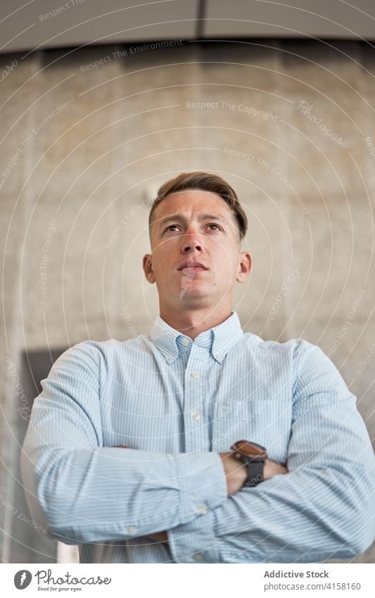 Stylish male entrepreneur standing on the street businessman downtown wait accuracy style city busy urban contemporary job confident modern manager work serious