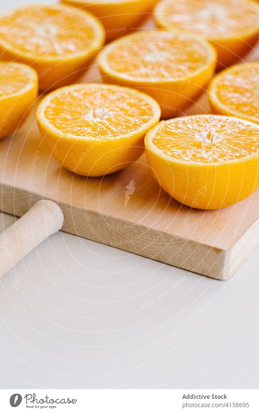 Oranges on cutting board on white background half orange arrangement line order row studio fruit wooden ripe vegetarian food chopping board fresh nutrition diet