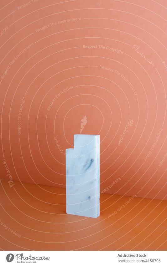 Piece of marble placed on table in studio piece art shape geometry rectangle solid material stone style design simple natural minimal creative detail surface