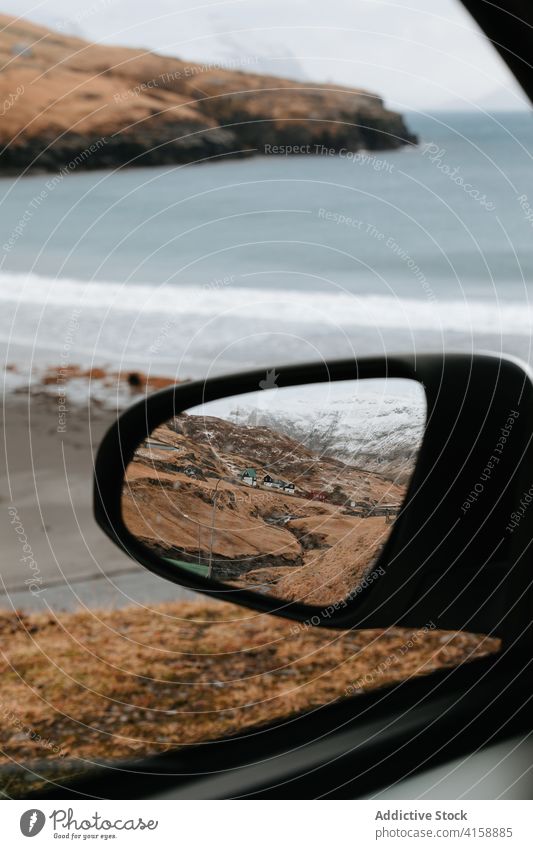 Car near sea in winter window car mountain road trip seascape snow highland landscape faroe islands amazing scenery sky journey calm cloudy automobile vehicle