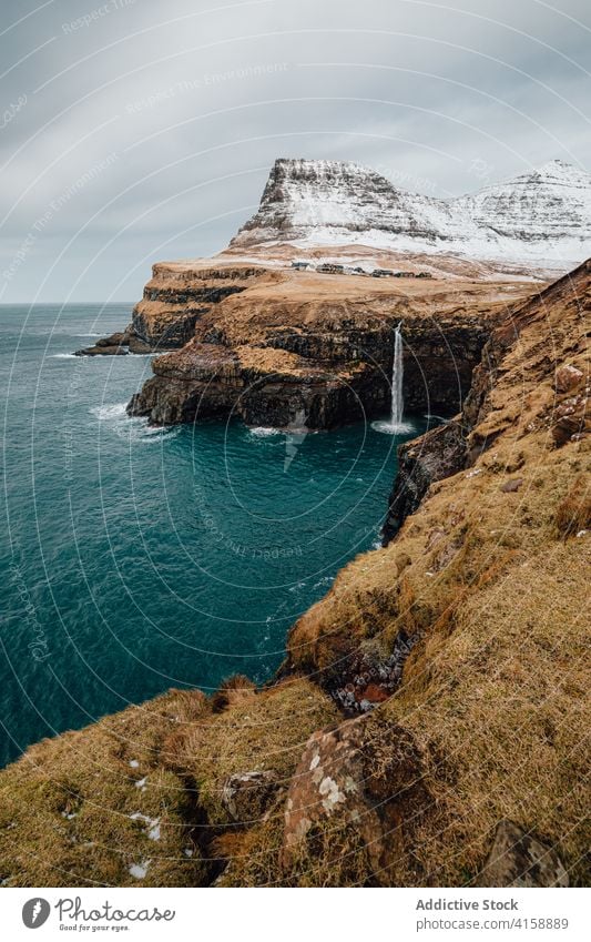 Small settlement in mountains on Faroe Islands village winter snow river season cold house residential faroe islands scenery breathtaking scenic countryside