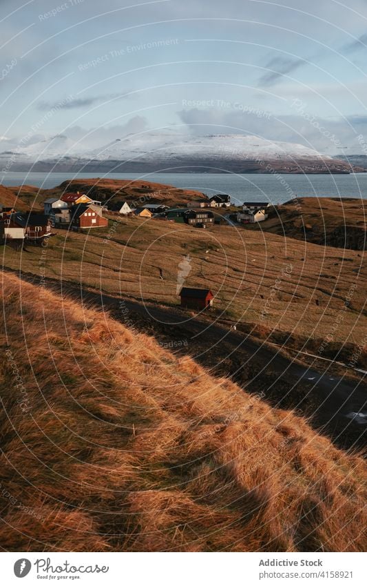 Small settlement in mountains on Faroe Islands village winter snow river season cold house residential faroe islands scenery breathtaking scenic countryside