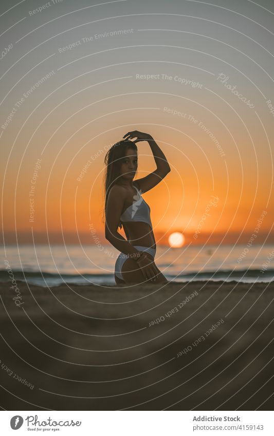 Woman in swimsuit on beach at sunset woman relax sundown slim shore seaside summer female vacation sky water sand holiday nature freedom paradise travel lady