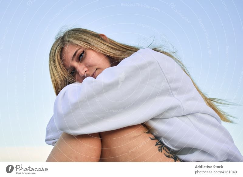 Tranquil woman sitting looking at camera traveler freedom carefree enjoy female piece journey adventure serene vacation rest tourism young lady tourist